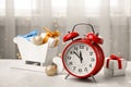 Retro alarm clock, gifts and festive decor on table