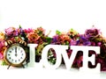 Retro alarm clock and love with flowers on white background Royalty Free Stock Photo