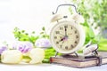 Retro alarm clock, notebook and spring flowers Royalty Free Stock Photo