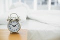 Retro alarm clock standing on a bedside table