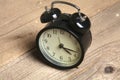 Retro alarm clock standing on vintage table Royalty Free Stock Photo