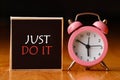 Retro alarm clock and the text `just do it `. Royalty Free Stock Photo