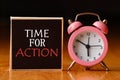 Retro alarm clock and the text `time for action `. Royalty Free Stock Photo