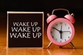 Retro alarm clock and the text `wake up `. Royalty Free Stock Photo