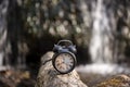 Retro alarm clock on waterfall background. Abstract photo of time Royalty Free Stock Photo