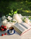 Bible near a bouquet of peonies