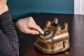 Retro antique classic outdated copper with black color rotary telephone from circa 1950s on wooden table, green wall Royalty Free Stock Photo