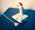 Retro arcade joystick with red button and interface bokeh background