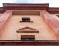 Close-up part of old building with small windows. Lower angle shot. Royalty Free Stock Photo