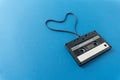 Retro audio cassete with magnetic tape in shape of heart.