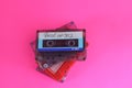 Retro audio cassette tape from the 80s and 90s on a red background. Royalty Free Stock Photo