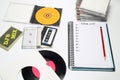 Retro audio cassette tape from the 80s and 90s on a white background. blank playlist on notebook. Top view, nostalgic concept.