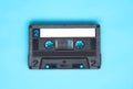 Retro audio cassette tape on turquoise background