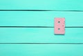 Retro audio cassette on a turquoise wooden background. Trend of minimalism.