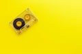Retro audio tape cassette from 80s and 90s isolated on yellow background. Old technology concept. Flat lay, top view with copy spa Royalty Free Stock Photo