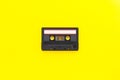 Retro audio tape cassette from 80s and 90s isolated on yellow background. Old technology concept. Flat lay  top view with copy Royalty Free Stock Photo