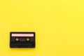 Retro audio tape cassette from 80s and 90s isolated on yellow background. Old technology concept. Flat lay, top view Royalty Free Stock Photo