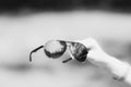 Retro aviator sunglasses model hold by hand in a summer day closeup . Selective focus