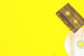 Retro background or banner. Cassettes and disk on a multi-colored yellow background. Blank with copyspace Royalty Free Stock Photo