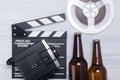 Retro background, with a set of items for viewing and a video camera with a film on the double for filming, with two beer bottles