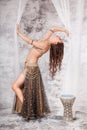 Retro belly dancer in backbend between drapes Royalty Free Stock Photo