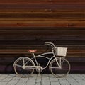 Retro bicycle with basket in front of the colorful wooden wall, background Royalty Free Stock Photo