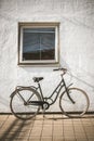 Retro bicycle on roadside with vintage concrete wall background Royalty Free Stock Photo