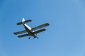 A retro biplane flying at high speed high in the air against a blue, cloudless sky Royalty Free Stock Photo