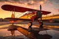 retro biplane parked on an airfield at sunset