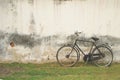 Retro Black Bicycle against Old Plastered Wall Royalty Free Stock Photo