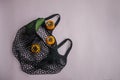 Retro black reusable eco friendly string bag. Inside, delicious avocados and persimmons. The concept of recycling, environmental