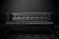 Retro black sofa in dark room
