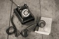 Retro black telephone and books on old oak wooden table. Vintage style sepia photo Royalty Free Stock Photo