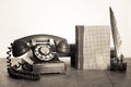Retro black telephone, books, quill and inkwel on old oak wooden table. Vintage style sepia photo Royalty Free Stock Photo