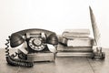 Retro black telephone, books, quill and inkwel on old oak wooden table. Vintage style sepia photo