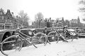 Retro black and white picture from snowy bicycles in Amsterdam Netherlands