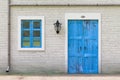 Retro Blue Door, Window, Gutter in Old Grunge White Brick Wall with Vintage Iron Lantern. 3d Rendering Royalty Free Stock Photo