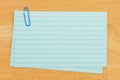 Retro blue paper index cards stack with paper clip on wood desk Royalty Free Stock Photo