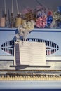 Retro blue piano, close-up. Vintage musical instrument with red flowers and notes Royalty Free Stock Photo