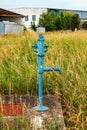 Retro borehole pump on a sunny day, old manual water pump (lever pump). Royalty Free Stock Photo