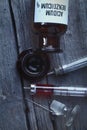 Retro bottle and syringes on the wooden background