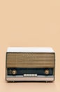 Retro broadcast radio receiver on peach color background