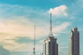 Retro broadcasting pole or radio signal tower on the top of the building in the city with the evening sky. vintage tone photo and Royalty Free Stock Photo