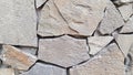 Mosaic tiled wall made with broken stone pieces. Uneven stone textured background. Brickwork rough backdrop. Stone masonry wall. Royalty Free Stock Photo