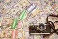 A retro camera on the background of money