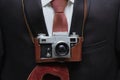 Retro camera with business suit background. Retro background. Royalty Free Stock Photo