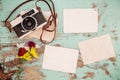 Retro camera and empty old instant paper photo album on wood table with flowers border design Royalty Free Stock Photo