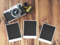 Retro camera, empty photo frames pictures and film canisterrs o Royalty Free Stock Photo