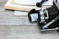 retro camera, film roll and photo frame on grey wooden background Royalty Free Stock Photo