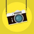 Retro camera in a flat style on a colored background. Old camera with strap. Vintage film camera. Vector illustration Royalty Free Stock Photo